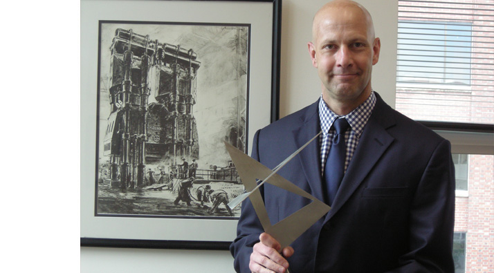 Joseph Dzierzawski proudly holds the award trophy.